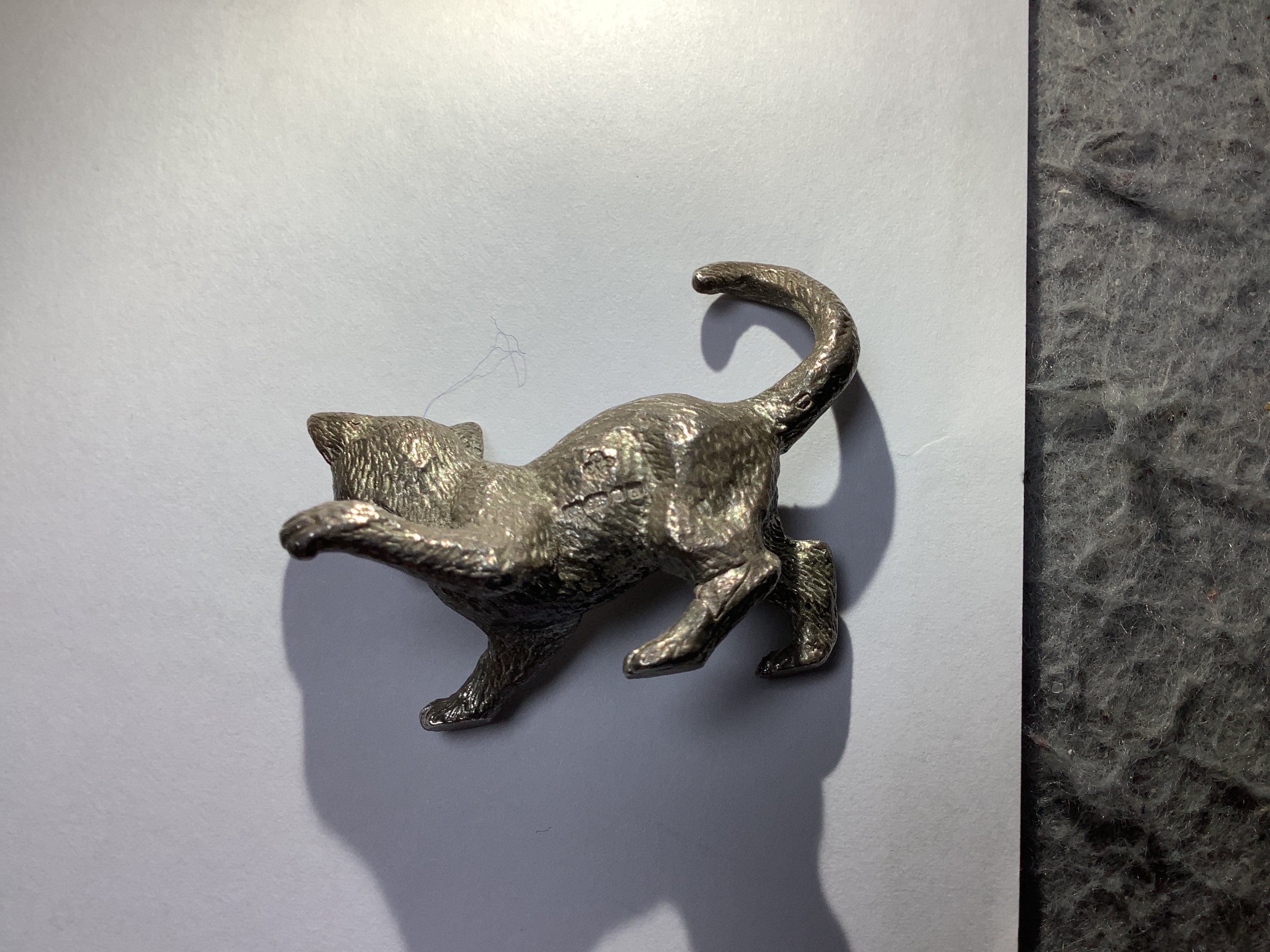 Two early 21st century silver miniature model animals, lion and playful kitten, London, 2003, lion length 55mm.